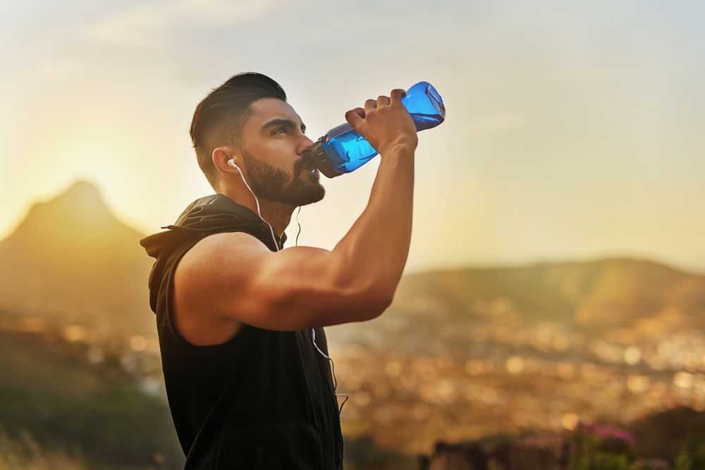 man-drinking-water-after-workout-mens-health-fitness
